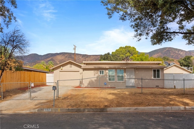 ranch-style home with a mountain view and a garage