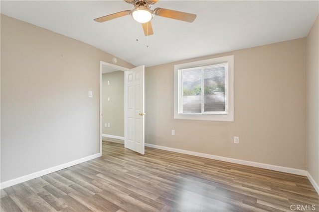 unfurnished room featuring light wood-type flooring and ceiling fan