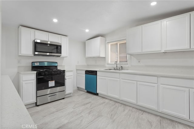 kitchen featuring sink, appliances with stainless steel finishes, and white cabinets