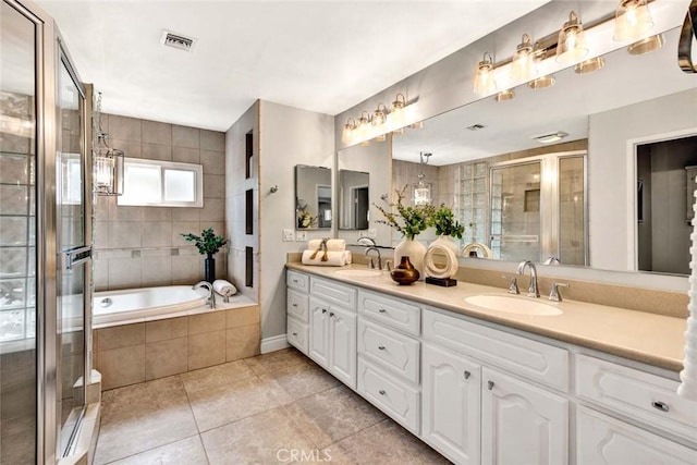 bathroom with shower with separate bathtub, vanity, and tile patterned floors