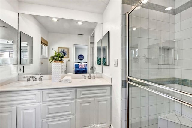 bathroom featuring vanity and an enclosed shower