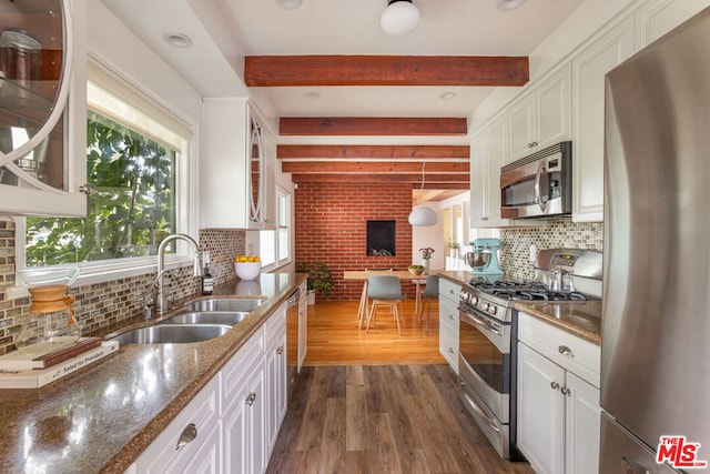 kitchen with white cabinets, beam ceiling, dark hardwood / wood-style flooring, and stainless steel appliances