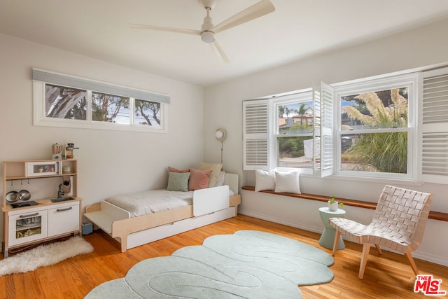 bedroom with ceiling fan and light hardwood / wood-style flooring