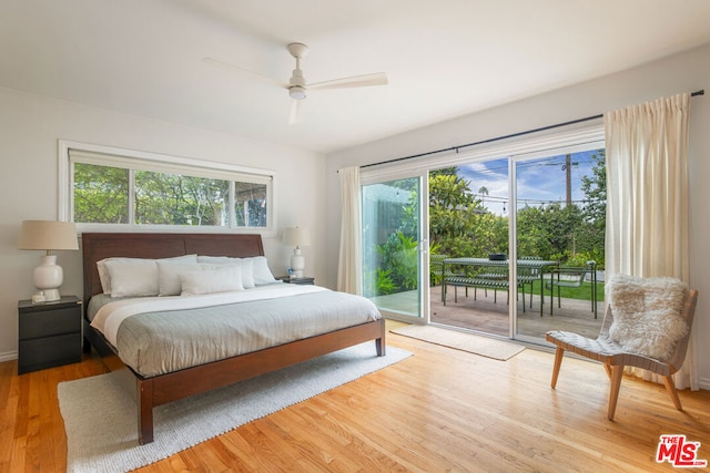 bedroom with hardwood / wood-style floors, ceiling fan, access to outside, and multiple windows