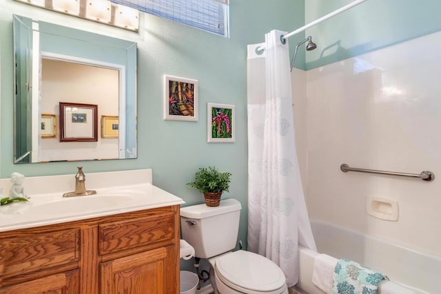 full bathroom with toilet, vanity, and shower / bath combination with curtain