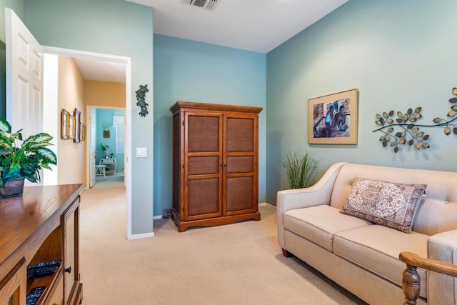 sitting room featuring light colored carpet