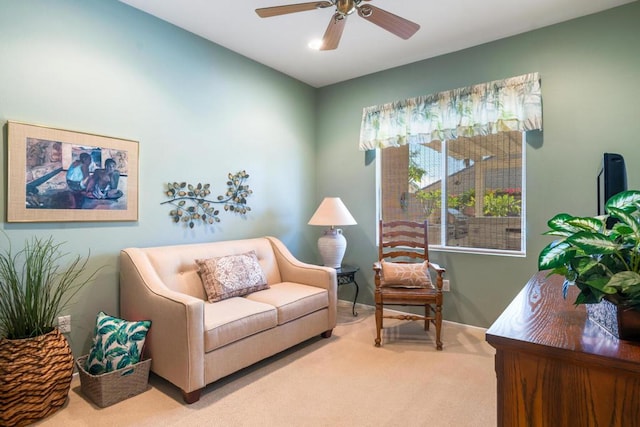 sitting room featuring ceiling fan and carpet floors