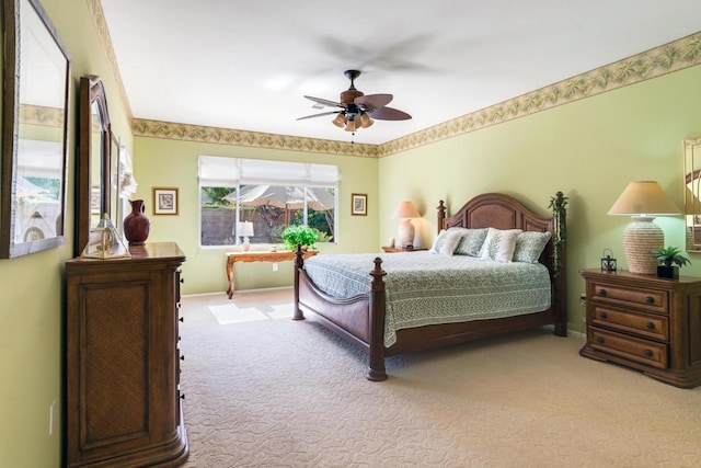 bedroom with ceiling fan and light colored carpet