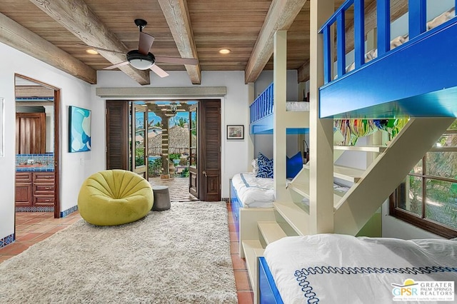 living room featuring a wealth of natural light, beamed ceiling, wooden ceiling, and ceiling fan