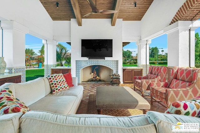 view of patio / terrace featuring ceiling fan and exterior fireplace