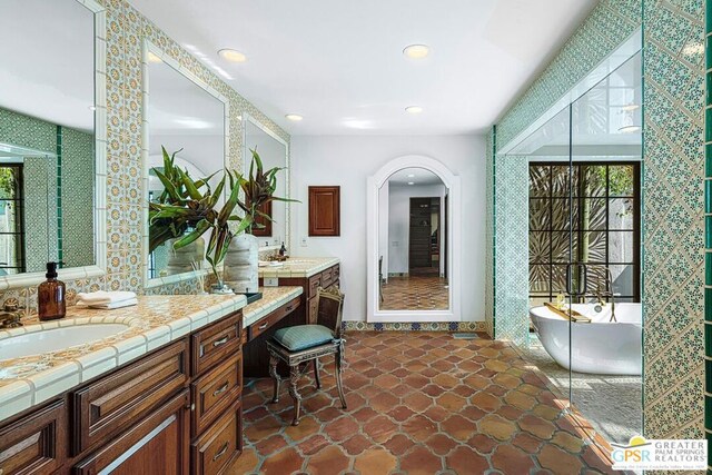 bathroom with vanity and a bath