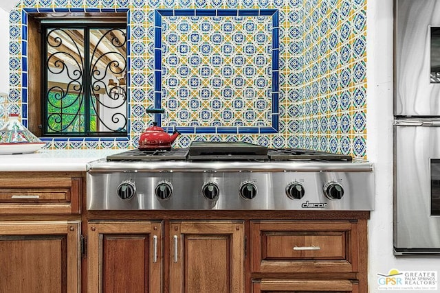 room details featuring tasteful backsplash and stainless steel gas stovetop