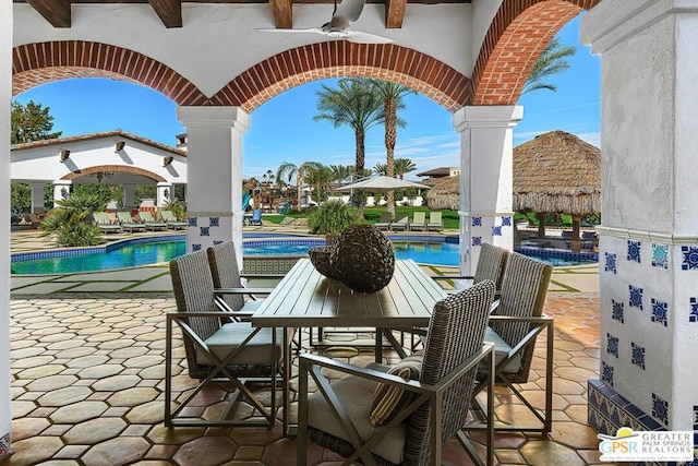 view of patio featuring ceiling fan and a community pool