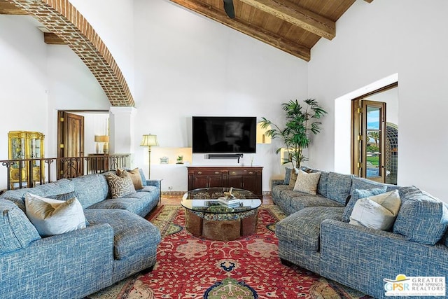 living room featuring beamed ceiling, wooden ceiling, and high vaulted ceiling