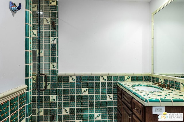 bathroom featuring vanity and tile walls