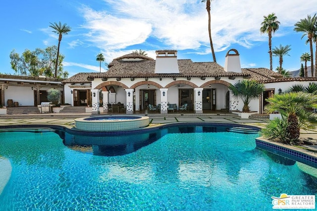 view of pool with an in ground hot tub and a patio area