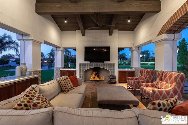 view of patio featuring an outdoor living space with a fireplace and ceiling fan