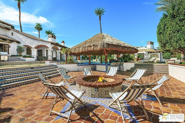 view of patio with a gazebo, grilling area, and an outdoor fire pit