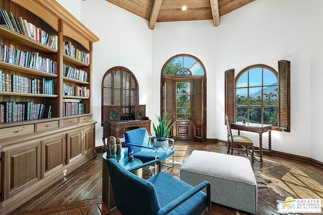 living area with beamed ceiling, dark hardwood / wood-style flooring, wooden ceiling, and high vaulted ceiling