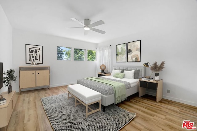 bedroom with light hardwood / wood-style flooring and ceiling fan