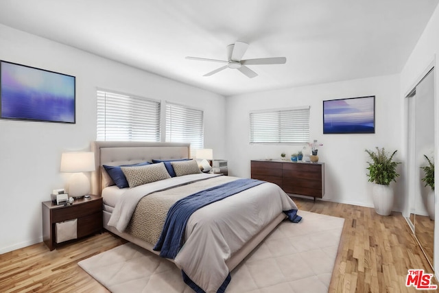 bedroom with light wood-type flooring and ceiling fan