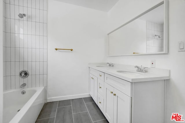 bathroom with tile patterned flooring, vanity, and tiled shower / bath combo