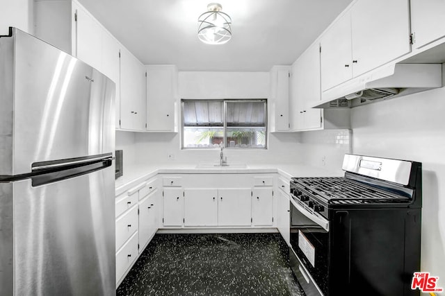 kitchen with black gas range, stainless steel fridge, white cabinetry, and sink