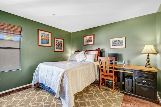 bedroom with hardwood / wood-style flooring