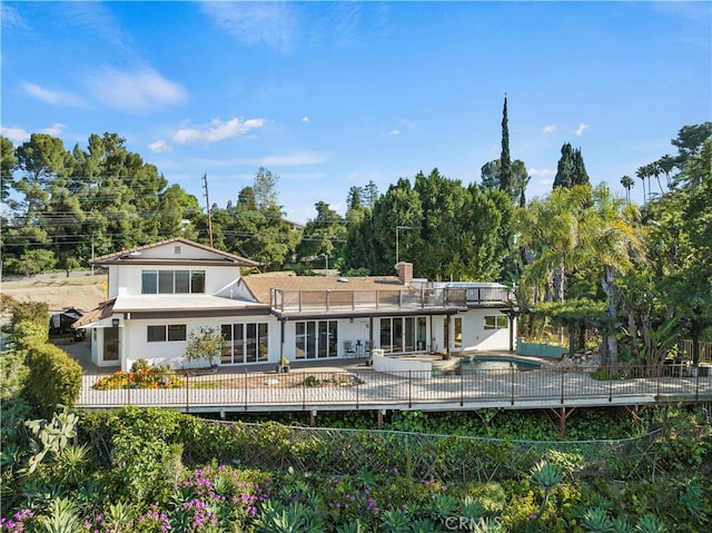 back of house with a patio and a fenced in pool