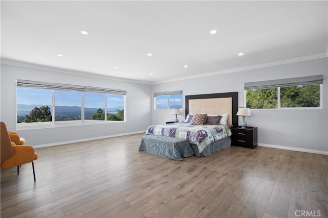 bedroom featuring light hardwood / wood-style floors and crown molding