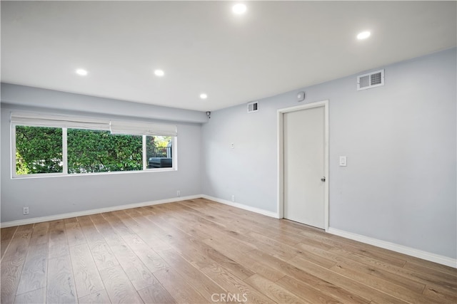 unfurnished room with light hardwood / wood-style flooring