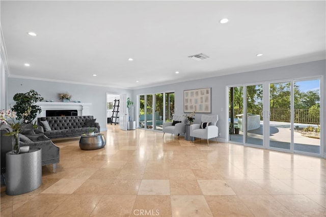 living room with ornamental molding and a wealth of natural light