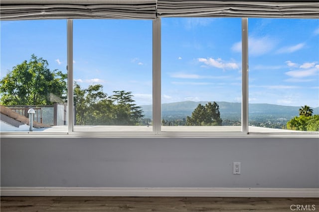 unfurnished sunroom with a mountain view