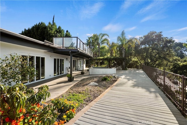 exterior space featuring a balcony and a patio area