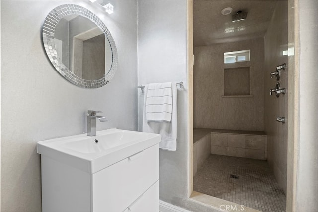 bathroom featuring vanity and tiled shower