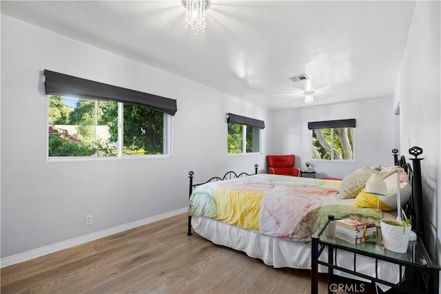 bedroom with ceiling fan and hardwood / wood-style flooring