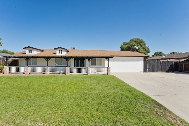 single story home featuring a porch, a front lawn, and a garage