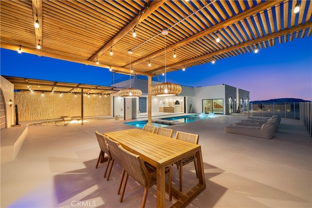 patio terrace at dusk featuring a fenced in pool