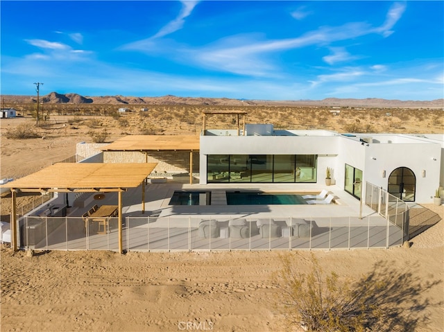 rear view of property with a mountain view and a patio