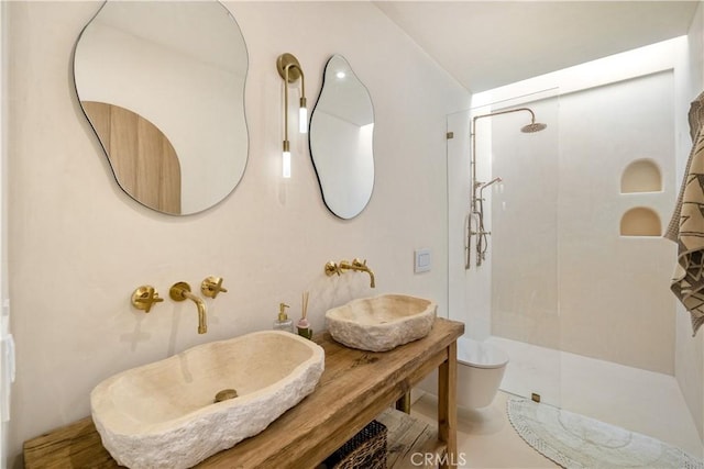 bathroom featuring a tile shower and sink