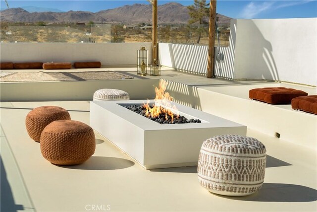 exterior details featuring a fire pit and a mountain view