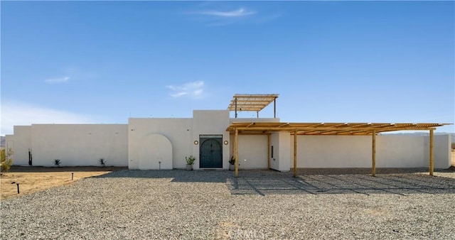 view of front of home with a pergola