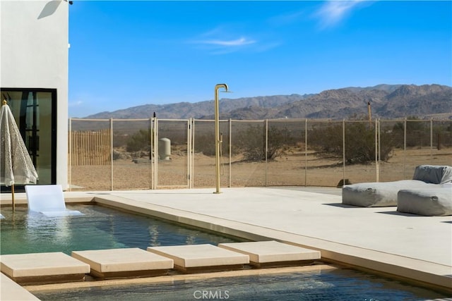 view of swimming pool featuring a mountain view