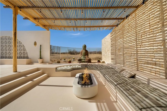 view of patio / terrace featuring an outdoor fire pit