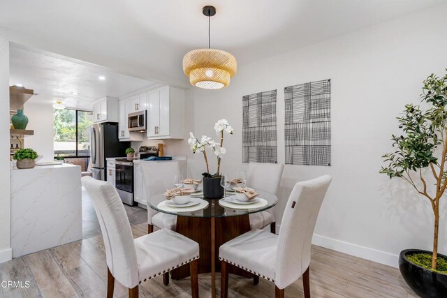 dining area with light wood-type flooring