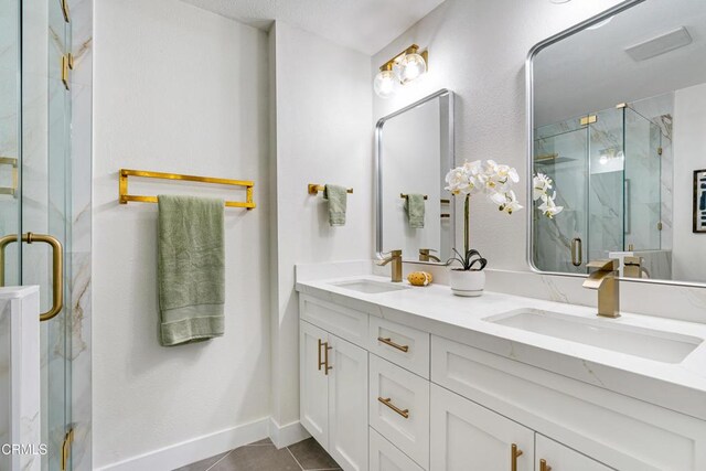 bathroom with tile patterned flooring, vanity, and an enclosed shower