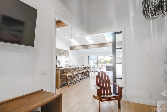 51 Catspaw, Coronado, CA 92118 - hall featuring recessed lighting, baseboards, a sink, vaulted ceiling with skylight, and light wood finished floors
