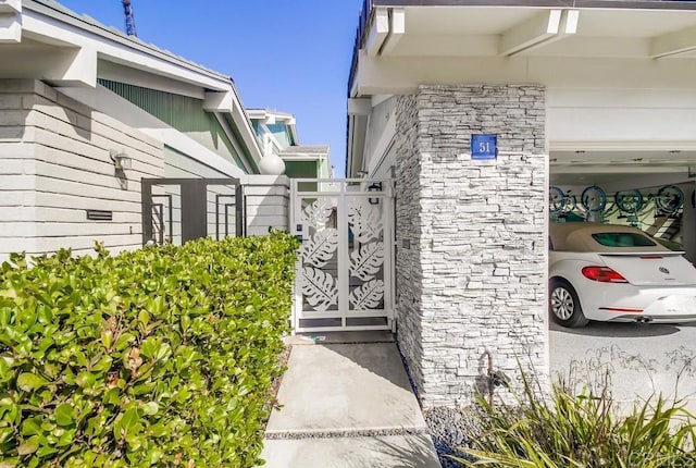 51 Catspaw, Coronado, CA 92118 - exterior space featuring stone siding and a gate