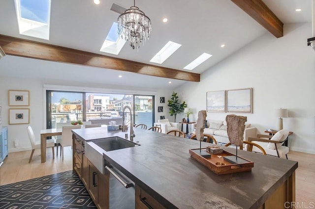51 Catspaw, Coronado, CA 92118 - kitchen featuring a skylight, light wood finished floors, dark countertops, beam ceiling, and a sink