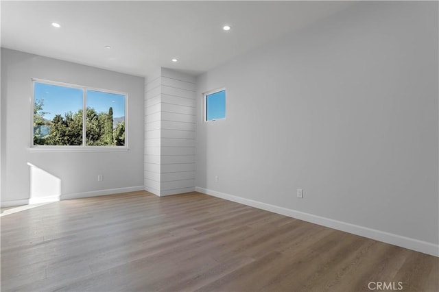 unfurnished room with light wood-type flooring